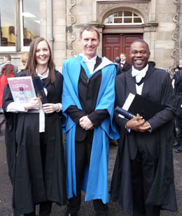 Recent graduates Dr Elliot Williams and Elizabeth Carson are congratulated by Dr Martin Campbell of the School of Psychology