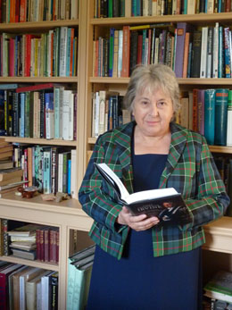 Julia Melvin holding a copy of 'James Colquhoun Irvine: St Andrews' Second Founder'