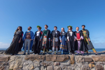 A group of graduates from the University of St Andrews in national dress on the Pier following Graduation