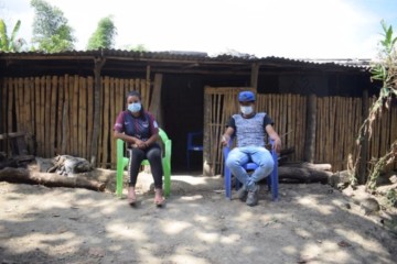 Rural migrants sit outside a house wearing masks in Peru during Covid-19