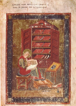 painting of medieval man in a library drawing in a book with a quill pen