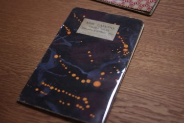 Hogarth Press publication of Woolf's 'Kew Gardens'. The cover is a dark, marbled, blue with orange flecks.
