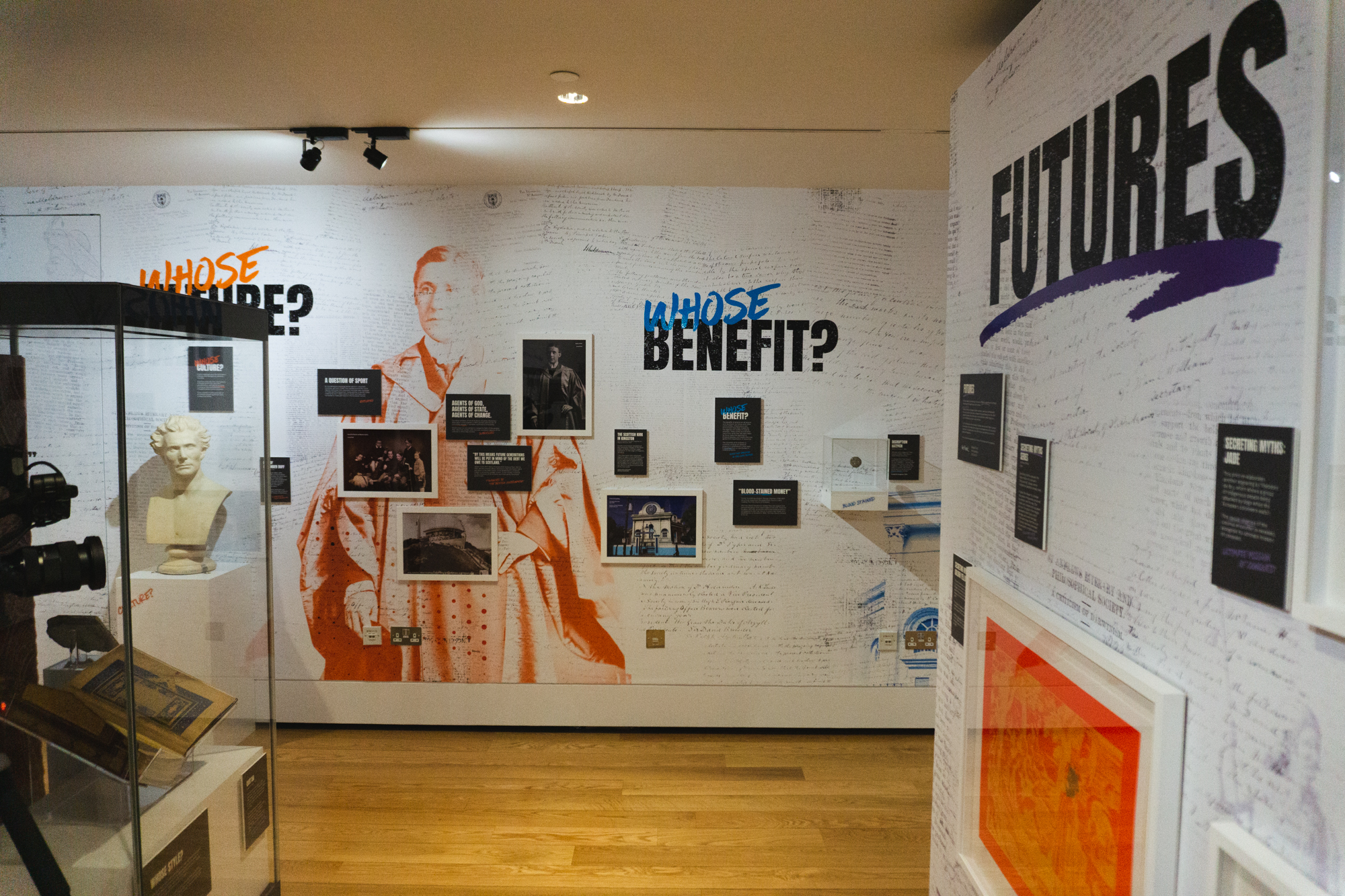 Picture shows items in the Wardlaw museum with signage behind reading 'Whose benefit'