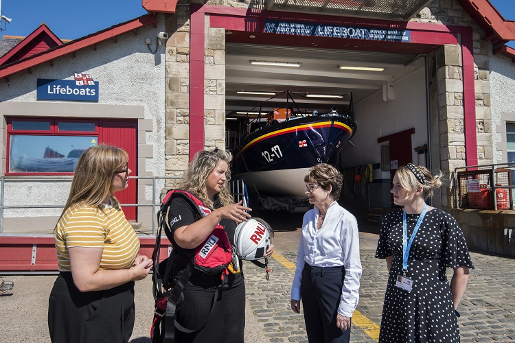 Pictured at Anstruther lifeboat station (from left), Community Engagement and Social Responsibility Officer Lesley Caldwell, lifeboat volunteer Emily Hague, Principal and Vice-Chancellor Professor Dame Sally Mapstone FRSE, and Claire MacDonald, Fundraising and Partnerships Lead, RNLI