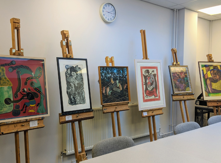 Five bright artworks on easels.