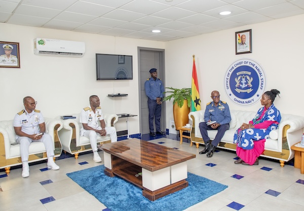 a group of leaders sit together in a large room