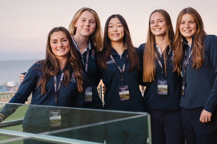 five smiling student golfers wearing branded golf gear